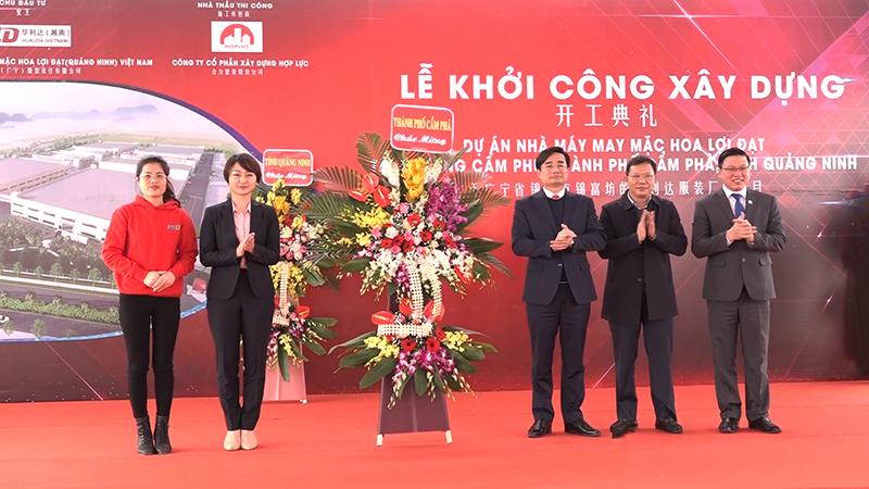 Các đồng chí lãnh đạo TP Cẩm Phả tặng hoa chúc mừng đại diện Công ty TNHH May mặc Hoa Lợi Đạt.